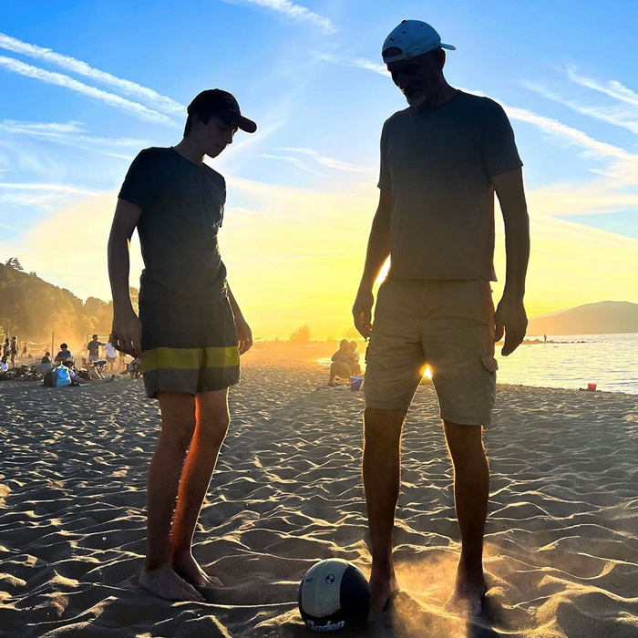 two people standing on the beach