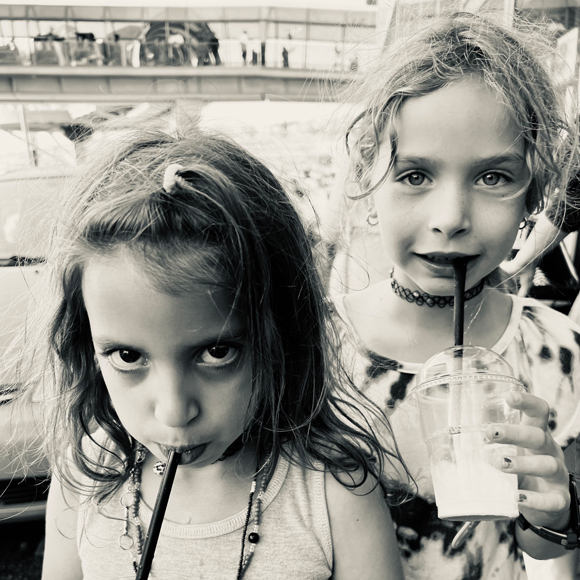 two girls drinks a shake